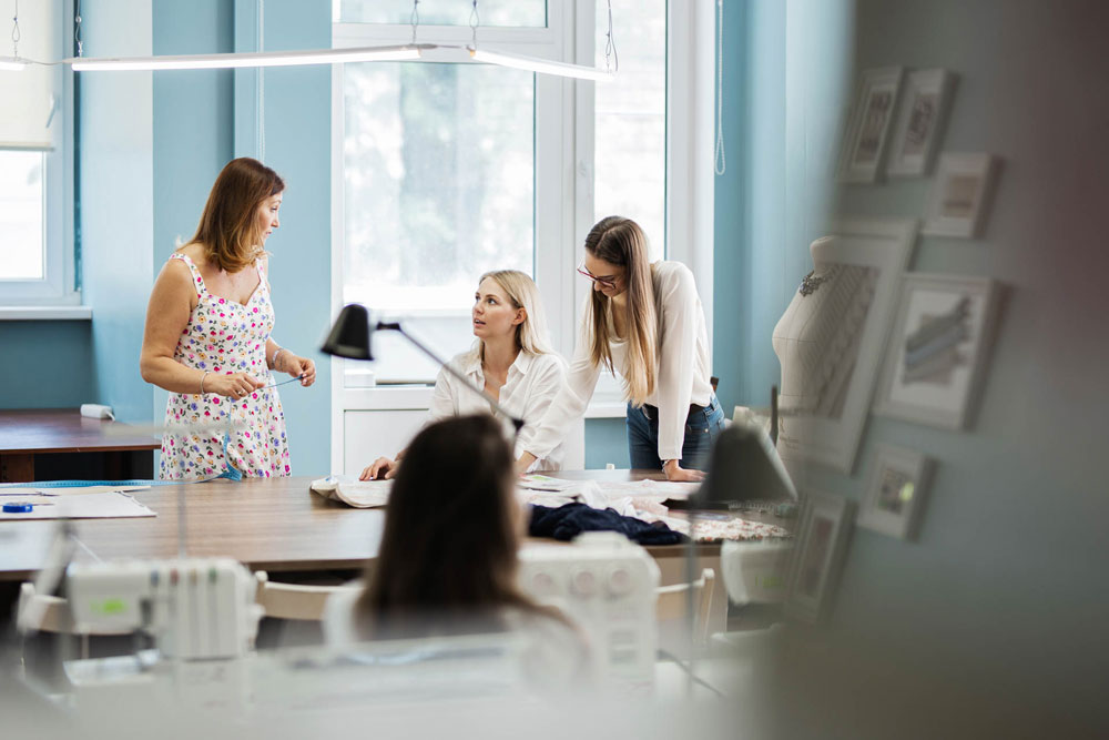 Three smart looking women having a discussion in an office